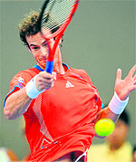 Andy Murray hits a return against Alexandr Dolgopolov during their final in Brisbane on Sunday