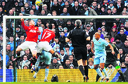 Wayne Rooney (L) scores against Manchester City during their FA Cup third round match on Sunday