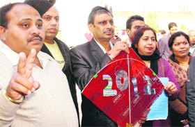 PPP candidate Lajpat Rai Chappu with his party symbol (kite) on his way to file his nomination papers in Rajpura on Thursday.