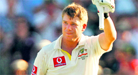David Warner celebrates his century in Perth on Friday.
