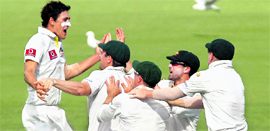 Australia�s Mitchell Starc (L) celebrates the wicket of Gautam Gambhir in Perth on Saturday.