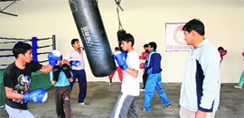 Chief trainer Subodh Kumar (R) oversees training at the Akhil Kumar Boxing Club and Fitness Society in Rohtak.