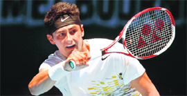 Bernard Tomic hits a return to Fernando Verdasco during their men's singles match at the Australian Open in Melbourne on Monday.