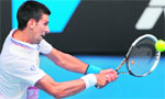 Novak Djokovic hits a shot against Nicolas Mahut in their third round match of the Australian Open in Melbourne on Friday. Djokovic won 6-0, 6-1, 6-1. 
