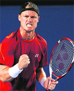 Lleyton Hewitt of Australia reacts after beating Milos Raonic