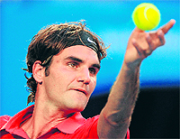 Roger Federer serves against Bernard Tomic in their fourth round match of the Australian Open in Melbourne on Sunday