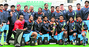 The Indian hockey team pose with the winners trophy after beating South Africa in the Test series at the National Stadium in New Delhi on Sunday