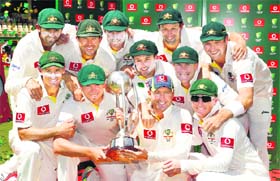 The Australian team pose with the Border-Gavaskar Trophy after winning the series 4-0 against India in Adelaide on Saturday