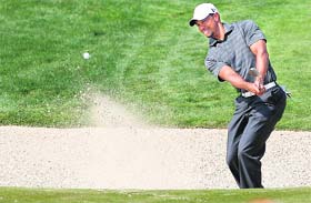 Tiger Woods plays a shot out of a bunker on the second hole during the third round of the Abu Dhabi Championship on Saturday