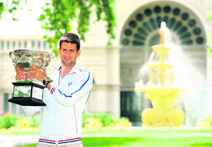 Novak Djokovic holds The Norman Brooks Trophy at a photoshoot after his victory in the men's singles final of The Australian Open in Melbourne on Monday.