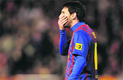 Barcelona's Lionel Messi reacts after missing a penalty during the Spanish Cup semifinal match against Valencia CF on Wednesday. 