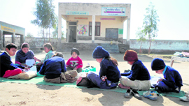 Students attend a class in the open at Government Primary School, Pakki Tibbi in Muktsar district.