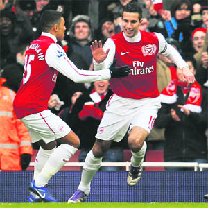 Arsenal�s Robin Van Persie (R) celebrates his goal against Blackburn Rovers with Alex Oxlade-Chamberlain during their English Premier League match in London on Saturday. Van Persie scored a hat-trick as Arsenal won 7-1. 