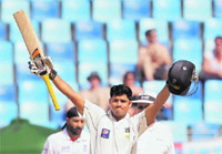 Pakistan�s Azhar Ali raises his bat to the crowd after scoring a century during the third day of the third Test against England in Dubai on Sunday.