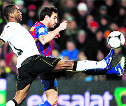 Barcelona's Cesc Fabregas (R) scores past Valencia's Luis Miguel Brito during their Spanish King's Cup semifinal in Barcelona on Thursday. Barca won 2-0 to set up a final clash against Athletic Bilbao