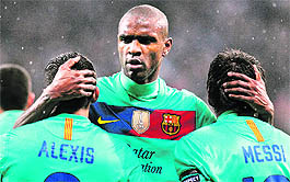 Barcelona�s Eric Abidal (C), Lionel Messi (R) and Alexis Sanchez (L) celebrate a goal during their UEFA Champions League match against Bayer Leverkusen in Leverkusen on Tuesday. Barcelona won 3-1. 