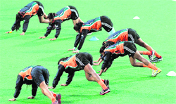The Indian women�s team stretch during a training session at the National Stadium in New Delhi on Friday. Indian eves take on Ukraine in the opening match 
