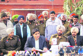 Police officers show fake currency notes seized in Patiala.