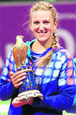 Azarenka with her trophy in Doha on Monday. 
