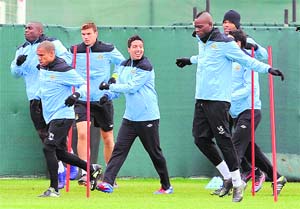 Manchester City's players warm up during a training session at their Carrington training complex in Manchester on Tuesday. Manchester City will play their Europa League match against Porto on Wednesday.