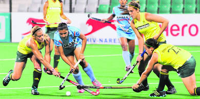 Indian (Blue) and South African women players in action during their match for the FIH London 2012 Olympic Hockey Qualifying tournament at the Major Dhyan Chand National Stadium in New Delhi on Wednesday.