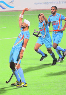Sandeep Singh (L) celebrates after scoring his second goal against Canada during their match for the FIH London 2012 Olympic Hockey Qualifying Tournament at the National Stadium in New Delhi on Wednesday. 
