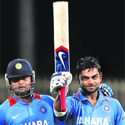 Virat Kohli (R) and Suresh Raina walk off the field after beating Sri Lanka in Hobart on Tuesday. India won by 7 wickets. 