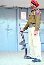 A security personnel stands guard outside a strongroom in Patiala.