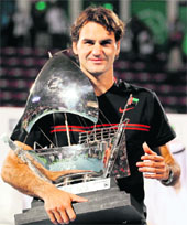 Roger Federer holds his trophy after beating Andy Murray in the Dubai Open final on Sunday