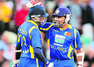 Sri Lanka�s Tillakaratne Dilshan (L) is congratulated by his captain Mahela Jayawardene after scoring his 50 against Australia in Brisbane on Tuesday.