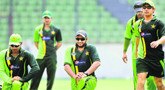 Pakistan�s Shahid Afridi (C) stretches with teammates during a training session at the Sher-e-Bangla Stadium in Dhaka 