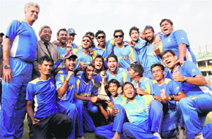 The Bengal cricket team celebrate with the winner's trophy after beating Mumbai in the final match of the Vijay Hazare Trophy in New Delhi on Monday. Bengal won by six wickets.