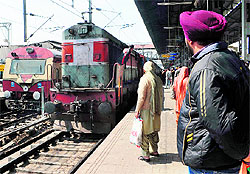 Passengers wait for a train at the Amritsar railway station