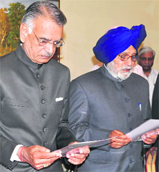 Governor Shivraj V Patil administers the oath of office to protem Speaker Charanjit Singh Atwal in Chandigarh on Saturday. 