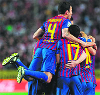 Barcelona players celebrates after scoring during their Spanish league match against Sevilla Fc in Sevilla on Saturday. barceloan won 2-0