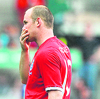 Wayne Rooney�s stray shot accidentaly broke a fan�s wrist.