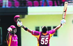 West Indies captain Darren Sammy (L) congratulates Kieron Pollard (R) after scoring a century against Australia in Gros Islet on Friday