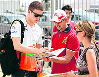 Force India Formula One driver Paul di Resta (above) of Britain signs an autograph as he arrives at the paddock ahead of the Malaysian Grand Prix at Sepang International Circuit outside Kuala Lumpur