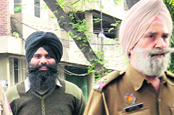 Balwinder Singh (in black turban) comes out of the Chandigarh district courts after being awarded capital punishment on Monday.