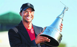 Tiger Woods hoists the championship trophy after winning the Arnold Palmer Invitational golf tournament at 