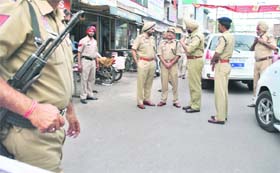 Police stages a flag march in Patiala on Tuesday on the eve of Punjab bandh