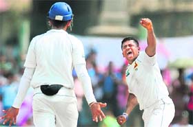 Sri Lankan spinner Rangana Herath (R) celebrates after dismissing England's Graeme Swann (unseen) during the fourth day of the opening Test at the Galle International Stadium on Thursday
