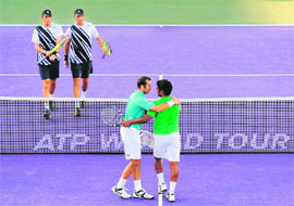 Bob Bryan and Mike Bryan (L) look on as Leander Paes and Radek Stepanek celebrate after their doubles match in Key Biscayne, Florida on Thursday.