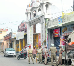 Police personnel outside a gurdwara in Begowal village.