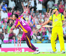 Australia�s Clint McKay (R) is bowled out by West Indies� Dwayne Bravo (L) during the 2nd T20 in Bridgetown on Friday. 