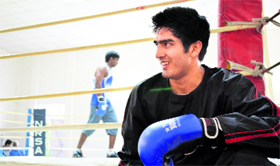 Vijender Singh takes a breather during a training session in New Delhi on Monday.