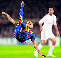 Barcelona's Daniel Alves kicks a ball during the Champions League quarter-final match against AC Milan in Barcelona on Tuesday. Barcelona won 3-1