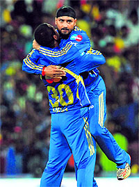 Mumbai Indians� captain Harbhajan Singh (R) celebrates the wicket of Chennai Super Kings� Dwayne Bravo with Pragyan Ojha in Chennai on Wednesday. Mumbai Indians won the match by wickets