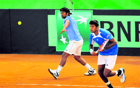 Leander Paes (L), and Rohan Bopanna in action during their Davis Cup match against Uzbekistan in Namangan, near Tashkent, on Saturday.