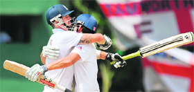 England�s Kevin Pietersen (L) and Alastair Cook celebrate their team�s victory on the final day of the second Test against Sri Lanka at the P. Sara Oval cricket Stadium in Colombo on Saturday.